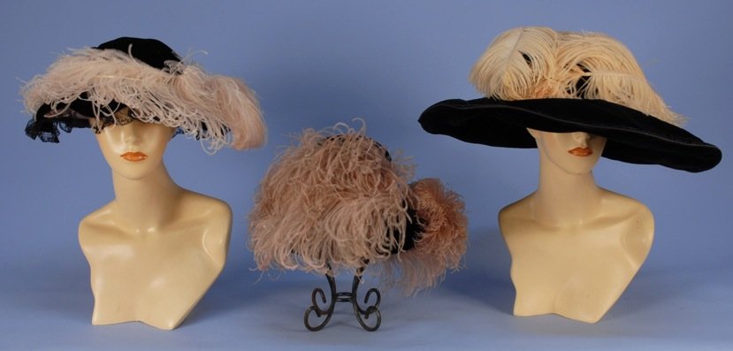 THREE BLACK VELVET HATS with PINK OSTRICH PLUMES, 1900: One toque. One oversized wide brim with Paris label (edge wear). One scalloped brim with lace trim, (lining torn). 10 - 23 inches. Good-excellent. MMA.