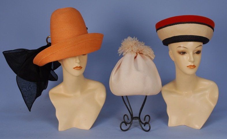 THREE HALSTON for BERGDORF GOODMAN HATS, 1960's.: One pale pink with pom-pom, one cream and navy striped with velvet brim band, one tangerine high crown with gilt ring and large silk gazar bow. All labeled "Made to Order Hat/ Bergdorf Goodman". Large