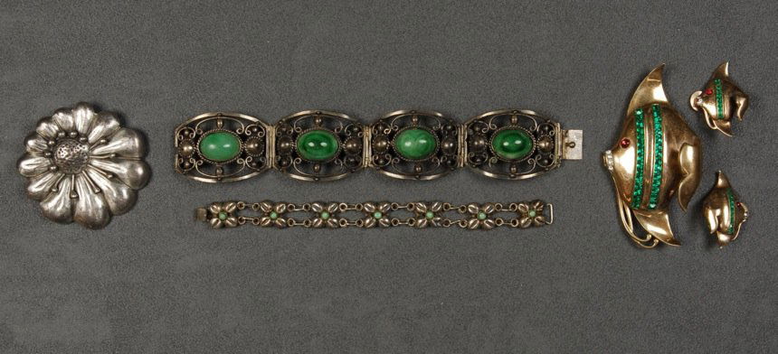 HECTOR AGUILAR STERLING SILVER PIN, 20th C.: Aguilar for Coro flower pin. Together with two Mexican bracelets set with stones and a pin and earring set of gold over Sterling silver in the form of a jeweled angelfish marked "C". Excellent.