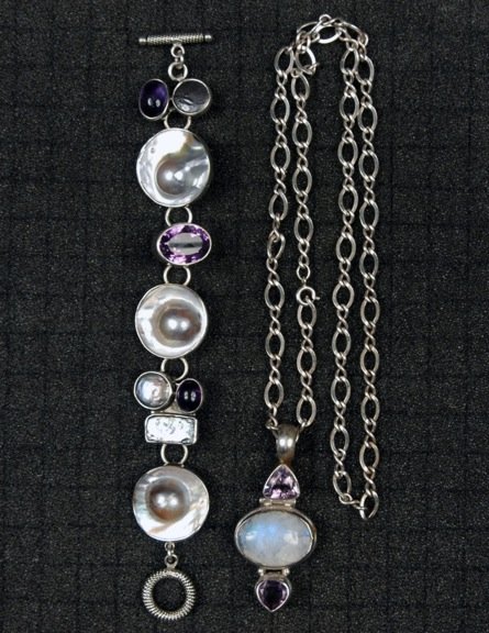 TWO PIECES STERLING and AMETHYST JEWELRY, 20th C.: One bracelet having six links set with mother of pearl or amethyst marked "RKR sterling", 1 x 7. One chain necklace with amethyst and white quartz pendant, marked "925", 14 3/4 drop. Excellent.