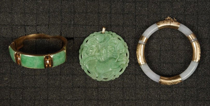 JADE PENDANT and TWO BANGLE BRACELETS, 20th C.: Circular carved green jade pendant depicting dragon in relief, 2 inch diameter. Two gold and jade bangles: One with three green jade panels and two tiny diamonds, one hinged white jade hoop spaced wit
