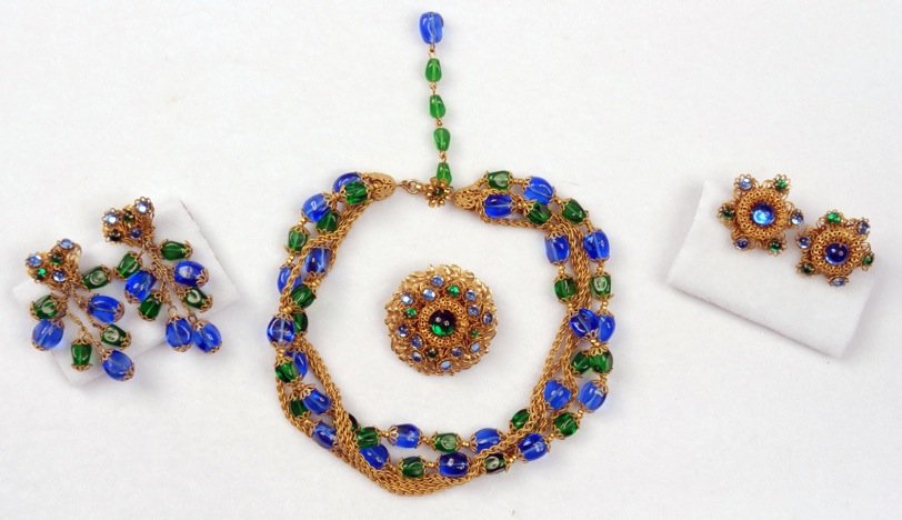MIRIAM HASKELL FOUR PIECE DEMI PARURE.: Multi-strand blue and green art glass and gilt chain necklace with matching pin and two sets of ear clips. Signed. Necklace 8 inches. Excellent.