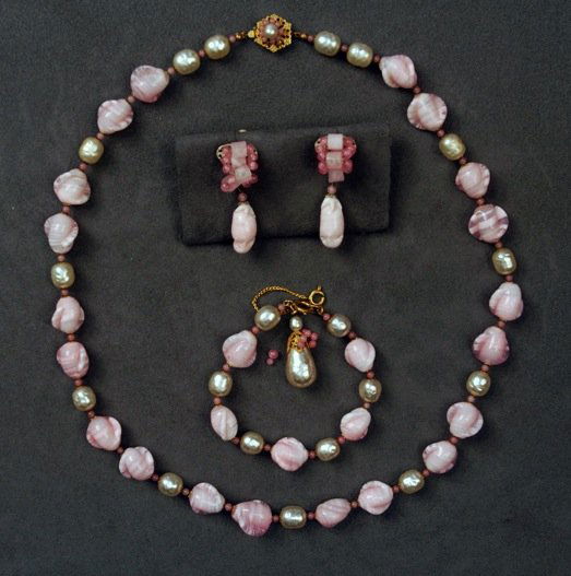 THREE PIECES MIRIAM HASKELL JEWELRY.: Necklace of pink art glass alternating with baroque pearl beads and matching bracelet set in gold filigree, ear clips of same construction set in silver filigree. Signed. Necklace 12 inches. (Small be