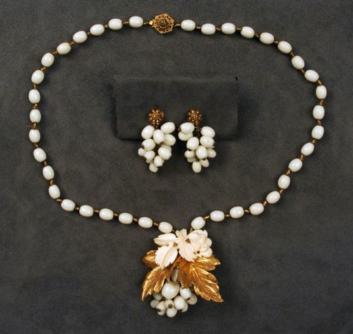 MIRIAM HASKELL NECKLACE and EARRING SET.: Necklace having white oval glass beads, gilt bead spacers and pendant with gilt leaf stampings, molded resin leaf and glass bead berry cluster, matching ear clips. Signed. Necklace 14 1/2 inches.
