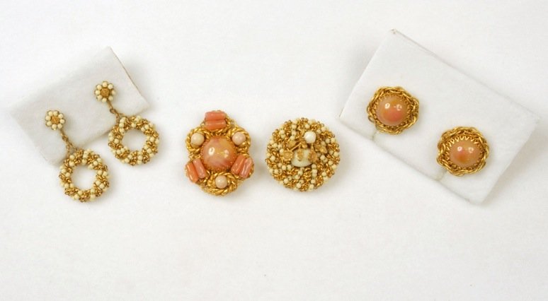 TWO MIRIAM HASKELL PINS with EARRINGS.: Both having cabochon and chain links mounted on gilt filigree, one round with ivory glass beads and gilt flowers, ear clips with hoop pendant, one oval having pink marbled glass ringed with pink cylin