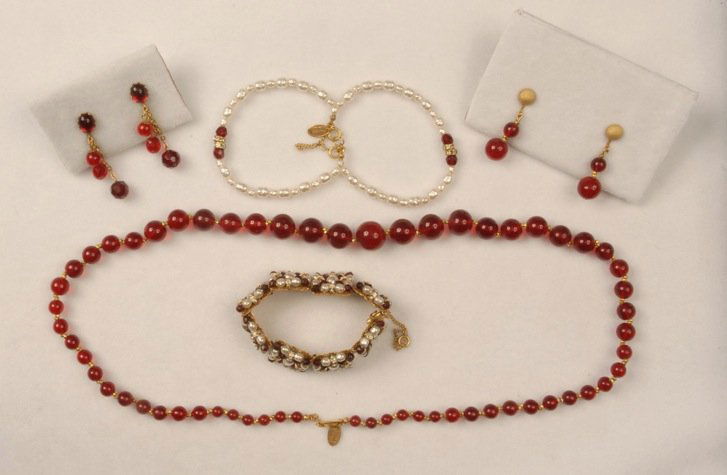 LOT of MIRIAM HASKELL JEWELRY.: Consisting of red glass bead necklace and matching ear clips, two bracelets with red beads, rhinestones and pearls, and a pair of earrings with faceted red beads. Signed. Necklace 13 1/2 inches. Excel