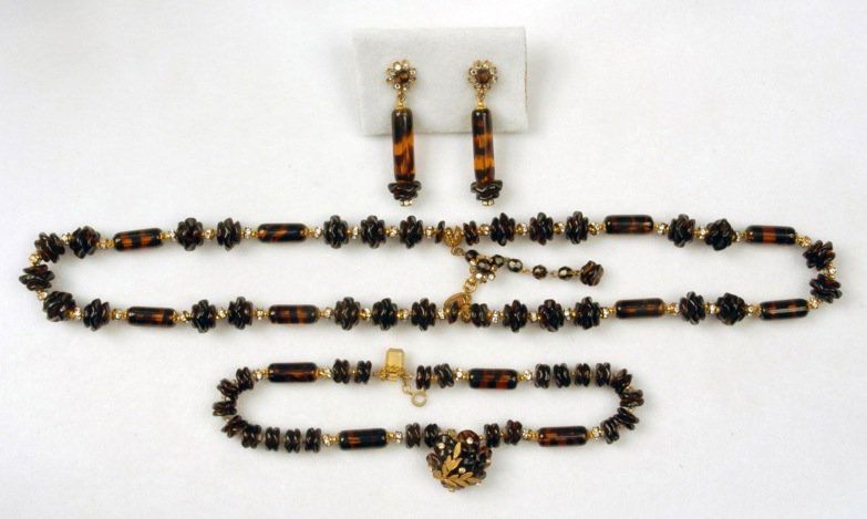 MIRIAM HASKELL DEMI-PARURE.: Double strand necklace and bracelet having ruffled art glass beads and billets in tortoise- like black and amber, with rhinestone rondelle spacers flanked by gilt beads, bracelet clasp covered in bead