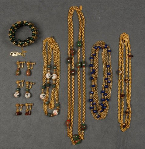 LOT of MIRIAM HASKELL JEWELRY.: Consisting of four gilt chain necklaces with bead separators, three having matching ear clips. Signed. Together with a deadstock memory wire cuff with beads. Necklaces 15 - 29 inches. Excellent.