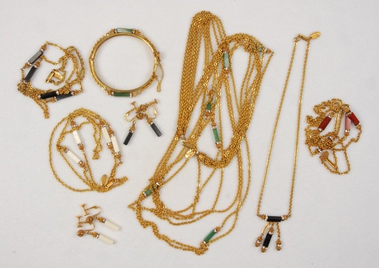 FIVE MIRIAM HASKELL GILT CHAIN NECKLACES.: All having rectangular spacers with rhinestone rondelles, three single chain in various colors, one with six graduated chains, one single chain with central pendant. Together with a matching bangle br