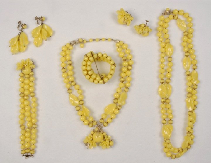 MIRIAM HASKELL SIX PIECE PARURE.: Lemon yellow round and ruffled glass beads, long necklace, double strand pendant necklace, triple strand bracelet, memory wire cuff and two pair ear clips. Signed. Necklaces 10 and 23 inches. (Some ve