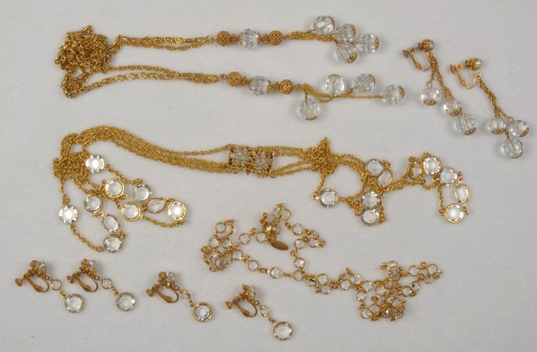 THREE MIRIAM HASKELL NECKLACE and EARRING SETS.: All gilt metal chains with faceted clear beads, one having side tassels, one four strand with stones at center, one alternating beads and links. Signed. Necklaces 10 - 16 1/2. Excellent.