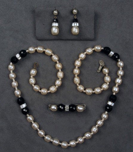 MIRIAM HASKELL DEMI PARURE.: Necklace of pearlized beads having spacer pairs of black faceted glass beads with rhinestone rondelle, matching bar pin and earrings. Signed. Necklace 14 inches. (Pin having losses, all beads retained