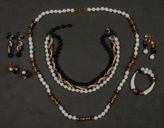 LOT of MIRIAM HASKELL BLACK and WHITE JEWELRY.: Glass beads in various sizes, one demi parure having gilt metal capped beads, necklace, bracelet and ear clips, one 3-strand necklace with matching earrings and one pair similar ear clips. Signed. Nec