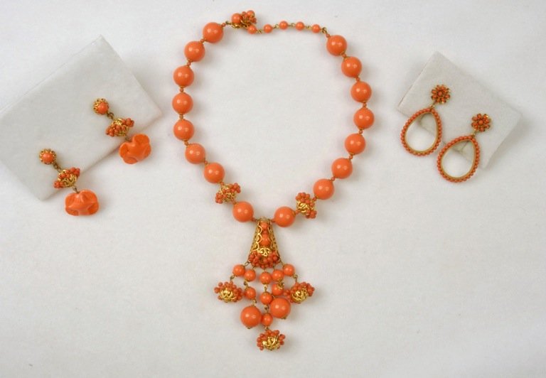 MIRIAM HASKELL NECKLACE and EARRING SET.: Necklace of large coral plastic beads separated by gilt filigree balls and tiny coral beads having girondole style pendant, matching ear clips having molded glass drop. Together with a pair of ear cli