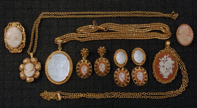 LOT of MIRIAM HASKELL CAMEO JEWELRY.: All molded glass or resin set in gilt metal ovals: Three link necklaces with pendant, two pins and three pair ear clips. Signed. Largest necklace 12 inches with 2 1/2 inch pendant. Excellent.