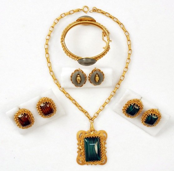 MIRIAM HASKELL NECKLACE and EARRING SET.: Faux malachite glass pendant on gilt chain with matching ear clips. Together with a pair of ear clips of the same design in faux tiger's eye, a hinged bracelet with grey almond shaped separators and s