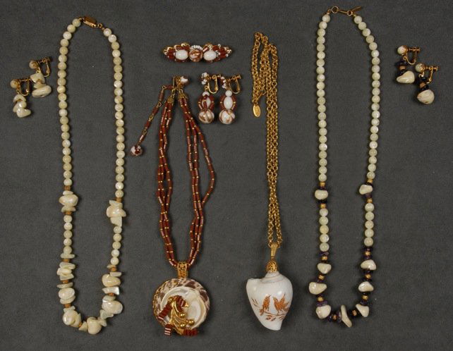 LOT of MIRIAM HASKELL SHELL JEWELRY.: One gilt chain with carved shell pendant, one demi parure with pendant necklace, pin and earrings, two glass bead and shell necklaces with earrings. Signed. Necklaces 10 - 13 inches. (One pair earring
