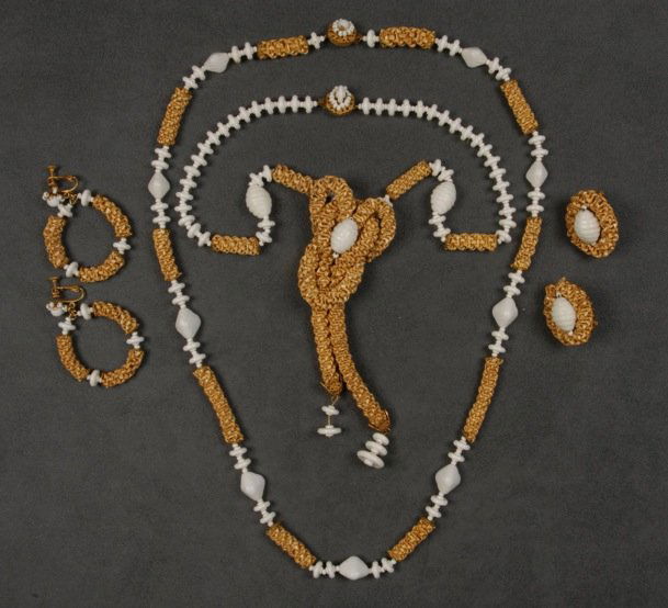 LOT of MIRIAM HASKELL RAFFIA JEWELRY.: All having braided raffia with white glass and plastic beads, two necklaces, one with pendant and two pair clip earrings. Signed. Necklaces 15 inches. (Pendant finial missing one plastic disk) good-ex