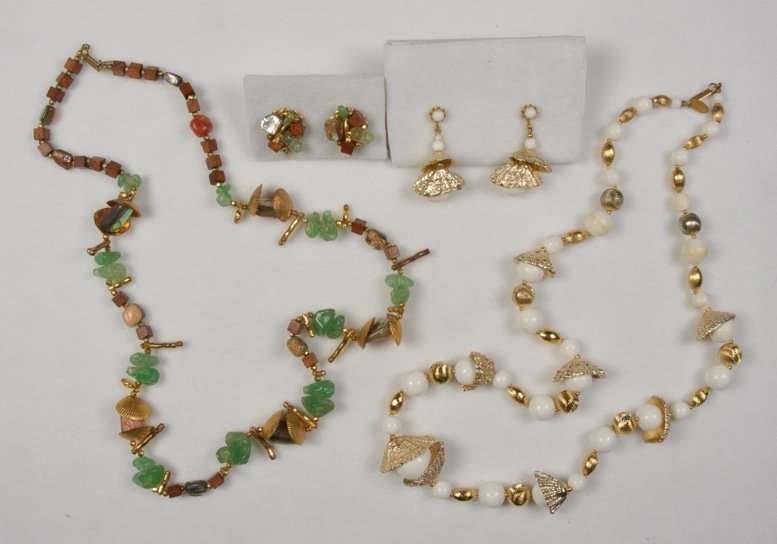 LOT of MIRIAM HASKELL SHELL JEWELRY.: Two necklaces having gilt shells, one with white and gold beads, one with gilt faux coral, wood and green resin beads, both having matching earrings. Signed. Necklaces 15 inches. Excellent.