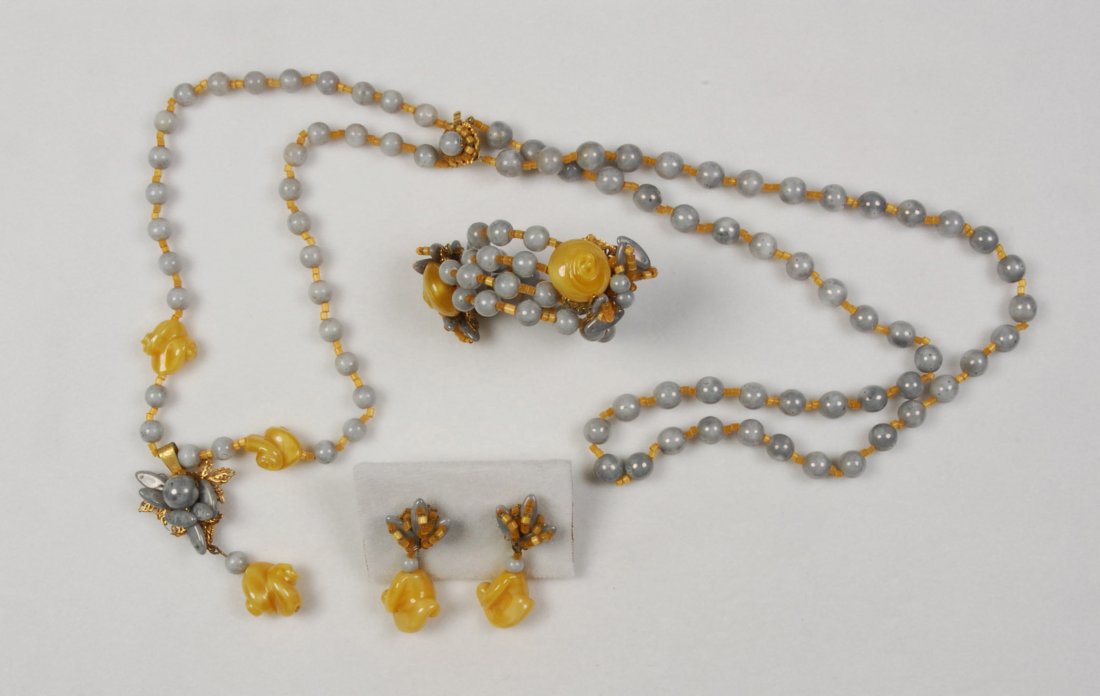 MIRIAM HASKELL DEMI PARURE.: Grey and ruffled butterscotch beads, double strand necklace with flower pendant, double strand memory wire bracelet and drop ear clips. Signed. Necklace 14 inches. (Bead loss to pendant and bracelet e