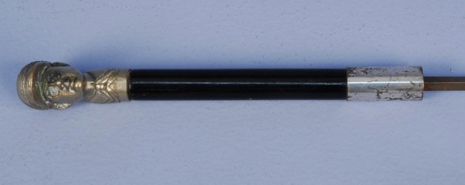 SWORD CANE with JOCKEY HEAD, EARLY 20th C.: Full relief head with cap and collar in white metal. Blade 20 3/4, overall 36 1/2. (Scratches to ferrule) good.