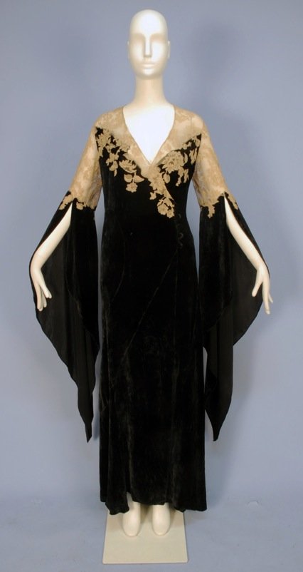 VELVET and LACE DESHABILLE, with WIZARD SLEEVES, 1930's: Black bias cut silk panne velvet wrap with off center self button and loop closure, having sheer ecru Alencon lace bodice top and applique to velvet, curved skirt gores, lace topped long, pointed slee