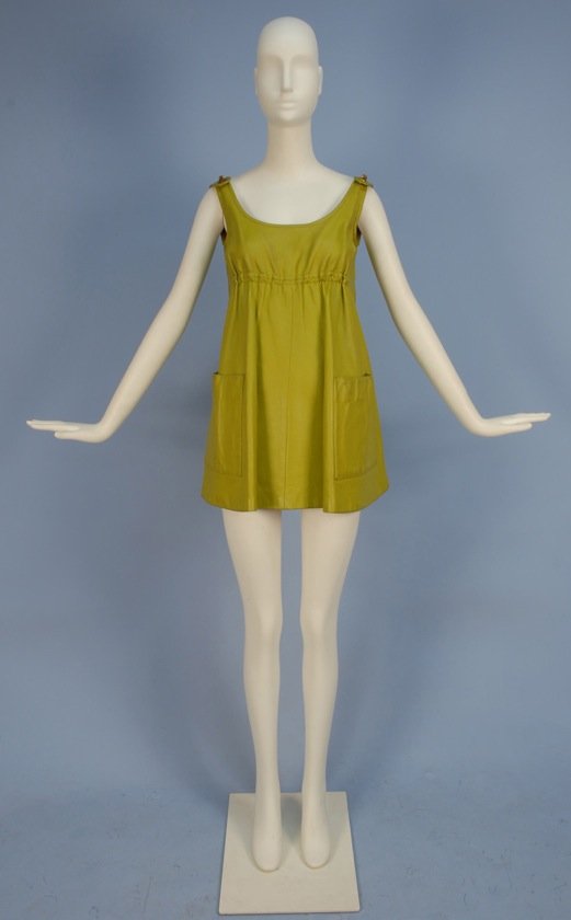 BONNIE CASHIN PROTOTYPE TUNIC, SPRING OPENING, 1966.: Pea green leather having scoop neck with turnbuckle clasps at either shoulder, cinched empire waist and large patch pockets, lined in bubble gum pink satin. Sills label. B-32, L-30. Together with orig