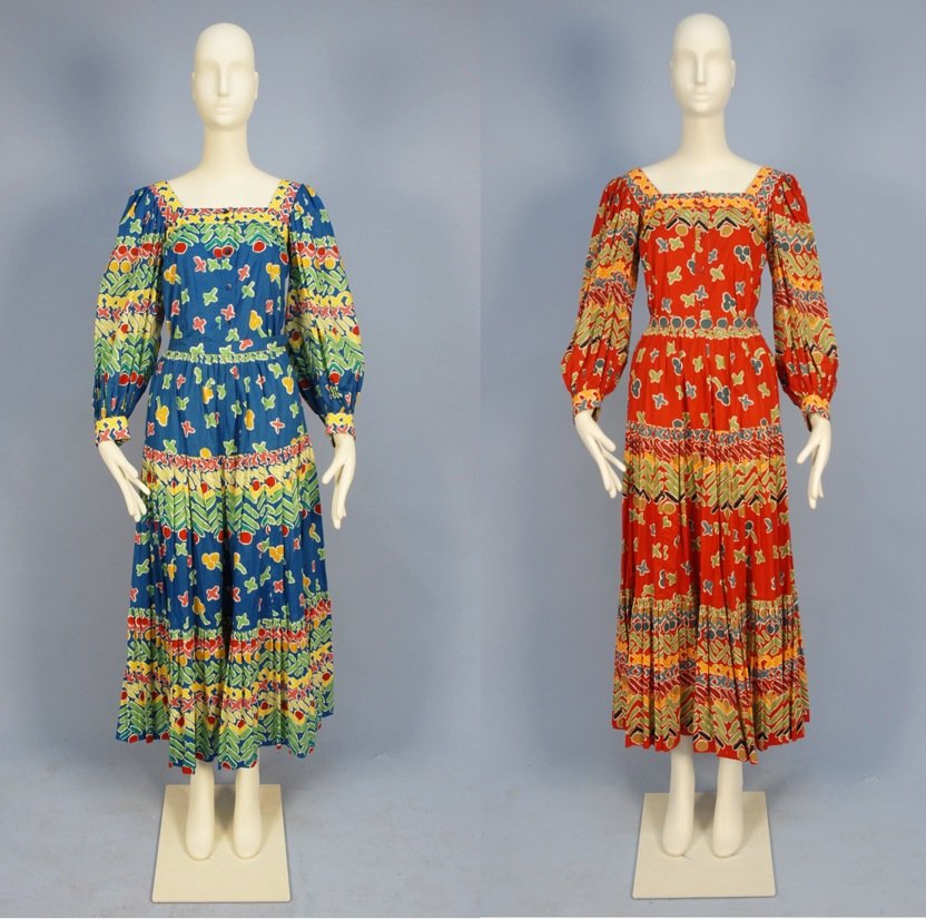 TWO SAINT LAURENT RIVE GAUCHE PRINTED COTTON PEASANT DR: Both 2-piece with colorful abstract prints having square neck blouse with full sleeve and full 3-tiered skirt, one red ground, one blue ground. Labeled. Both marked size 38. (Zipper on red skirt off t