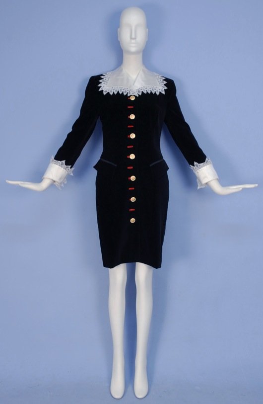 ESCADA VELVET COAT DRESS, 1980's.: Black cotton with lace collar and cuffs, angled pockets and gilt logo buttons with rhinestones. Labeled. B-34, W-30, H-38, L-39. Excellent.