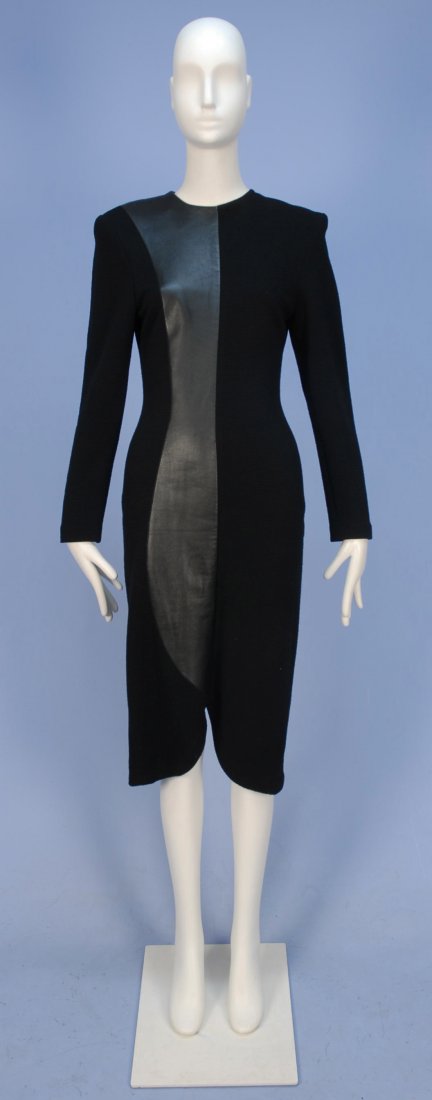 ITALIAN WOOL KNIT DRESS with LEATHER PANELS, 1980's.: Long sleeve black horizontal rib knit having asymmetrical black leather panel along center seam front and back with curved notch at hem, padded shoulder, back zipper. Label "Emanuel Zoo". B-36, W-28,
