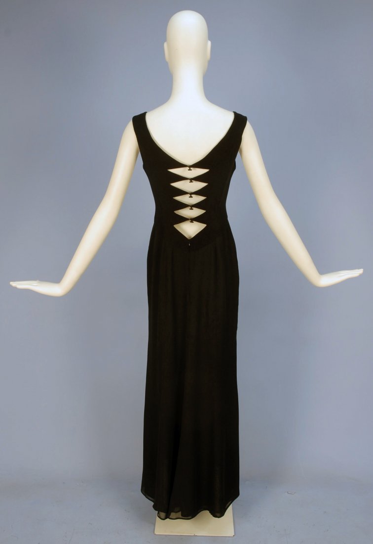 HERVE LEGER PARIS EVENING GOWN, 20th C.: Sleeveless black wool jersey top with square neckline, the V-back having five cutout diamond shapes with faux buttons over hooks & eyes, joined at waist to three layer chiffon skirt with back zipper.