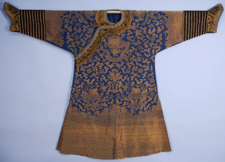 CHINESE SILK and GOLD METALLIC BROCADE DRAGON ROBE,: Blue silk decorated with nine gold dragons, cranes, clouds, bats, Buddhist emblems, etc. having deep li shui border, black lower sleeve, horse hoof cuff and neck band, unlined. 78 x 55. (Some wear to 