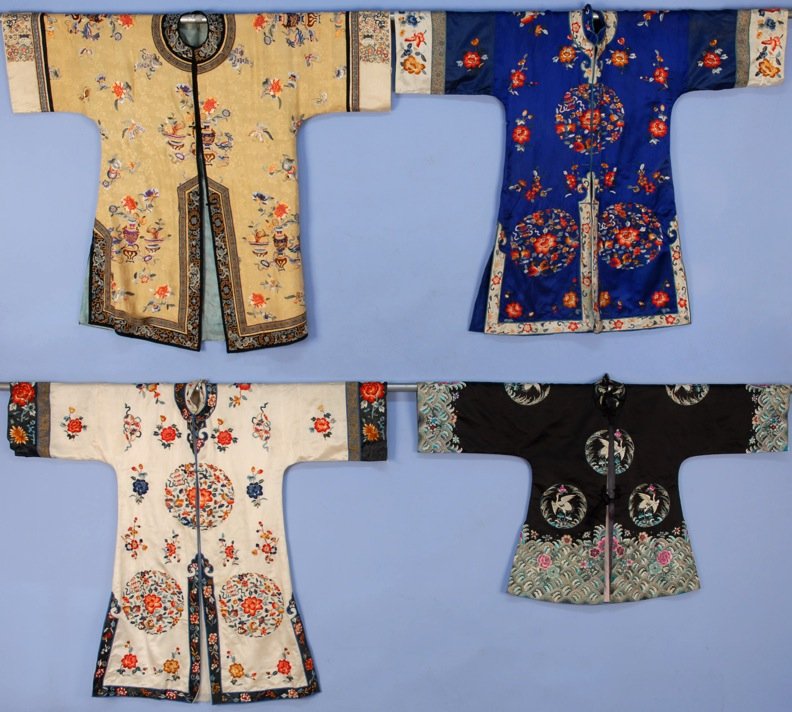 FOUR CHINESE SILK EMBROIDERED INFORMAL ROBES, 20th C.: Two having identical embroidery: one blue, one white. One black having turquoise and red embroidery. One gold with flowers and vases. Smallest 46 x 28, largest 52 x 42. Good-excellent.