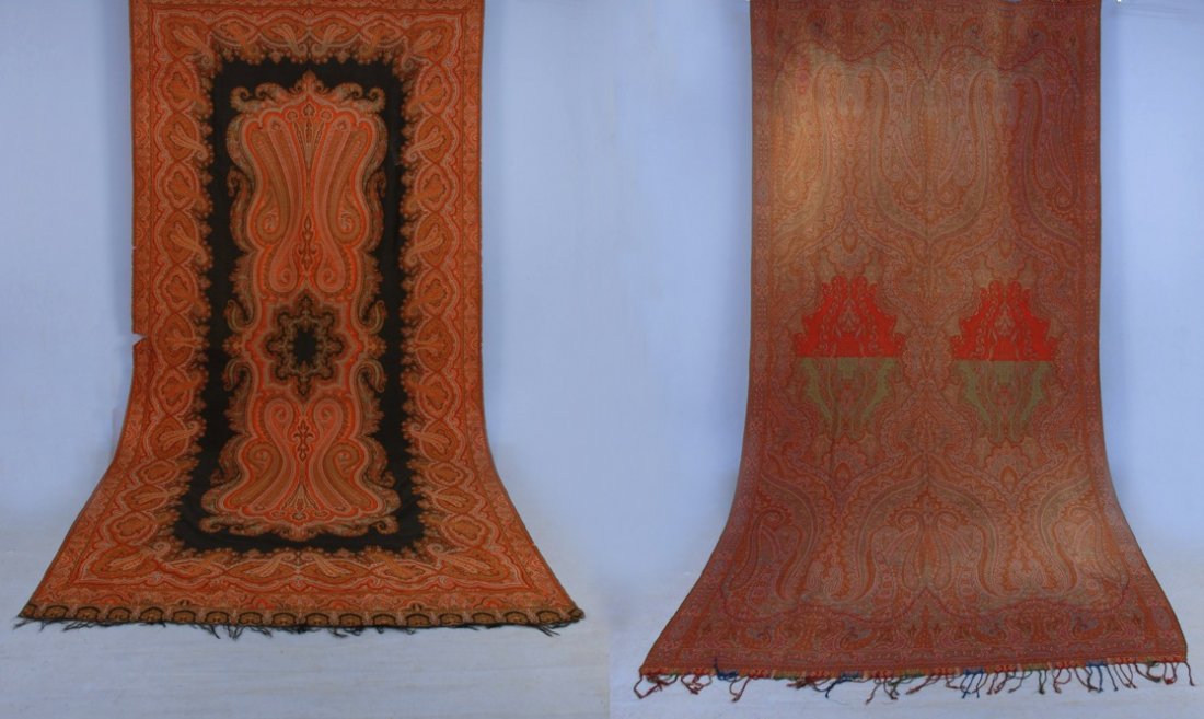 TWO PAISLEY SHAWLS, 19th C.: Both long rectangular form: One with green and red lozenges, excellent. One with black center (holes and tears) fair. Both approximately 60 x 124.
