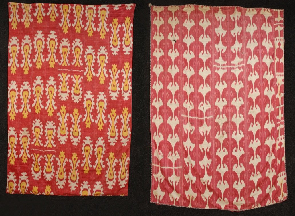 TWO SILK IKATS, 20th C.: One red, yellow and white vase design with red printed cotton backing, 48 x 76. Excellent. One red and white with "bird" design, 60 x 90, (holes, stains, unlined) fair.