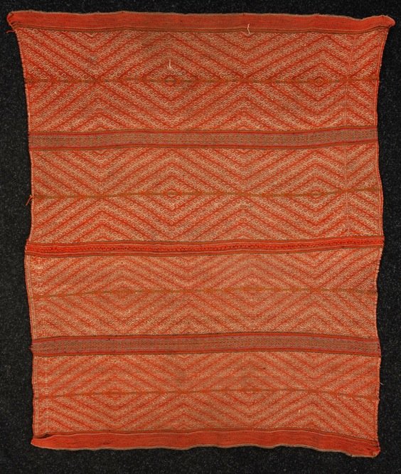 PERUVIAN LLICLLA OR SHOULDER CLOTH, 19th C.: Of camelid wool woven in two sections with latch hook design in red, white, orange and purple. 40 x 51. Very good.