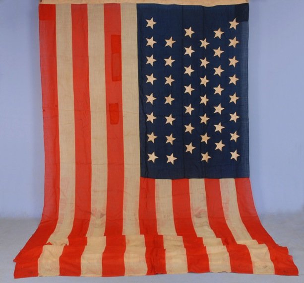 TWO AMERICAN FLAGS, 19th - 20th C.: One Wyoming statehood 1891-1895, 88 x 176, (several 1-2 inch holes, patches and stains). One 48 star flag, 48 x 72, (tears and holes). Both fair.