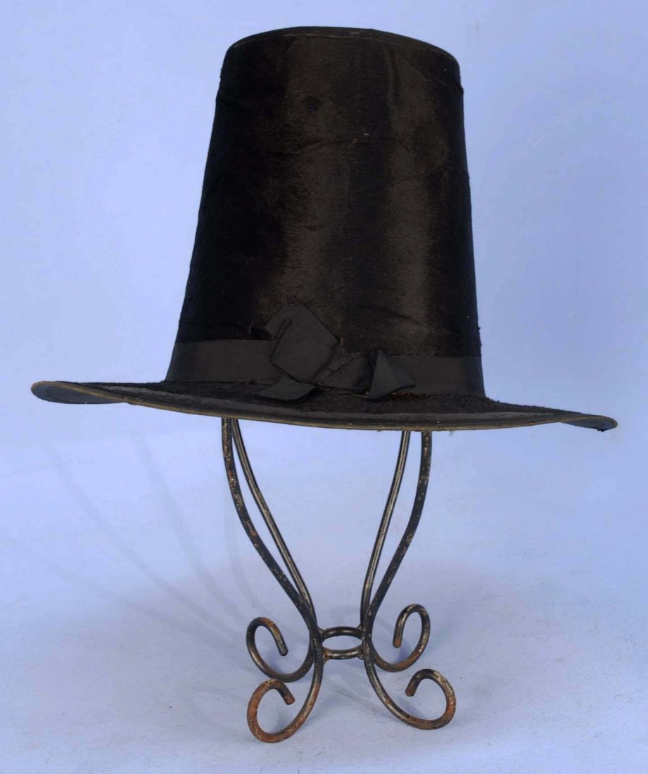 BRITISH GENT'S TALL HAT, 18th C.: Black sheared beaver with flat top truncated conical crown, black grosgrain ribbon band and brim binding, silk lining. 13 x 14 1/2 x 9 1/2 high. (Fur losses on brim, several tears to silk underbrim, w