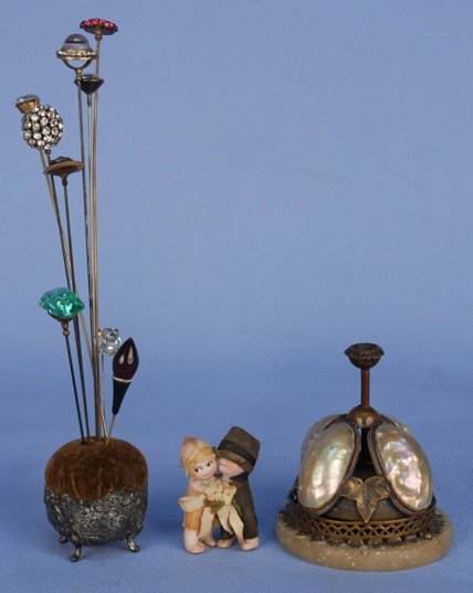 FRENCH SHOP BELL, 19th C.: Bronze color metal mounted with mother of pearl on alabaster base, 4 x 5 inches. Together with assorted hat pins, pin cushion and Kewpie wedding cake topper. Excellent.