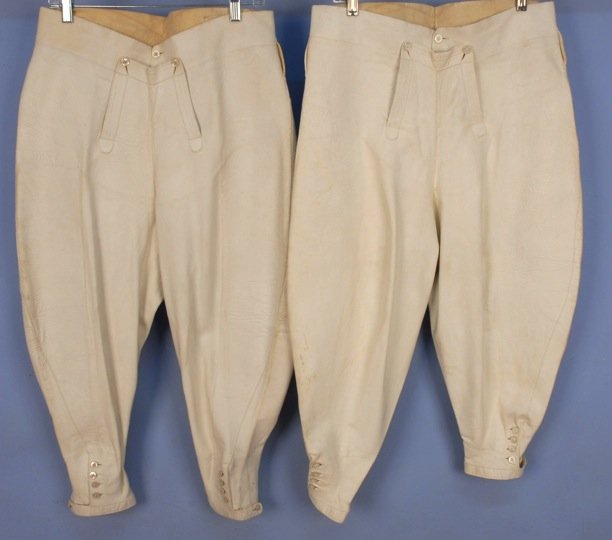 TWO PAIR MEN'S FALL FRONT LEATHER JODPHURS, 1940's.: Both high waisted white kid with five belt loops, two hidden by topstitched fall front with mother of pearl buttons, back yoke, button cuff with strap, possibly for polo. W-33, L-35, inseam-21. (Minor