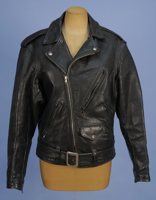 LADY'S HORSE HIDE MOTORCYCLE JACKET, c. 1947.: Belted black leather with three zippered and one snap flap pocket, zip front and wool lining with inside pocket. Labels: "Kit Karson Indian Scout" and "Made of Genuine Horse Hide Front Quarter". Prove