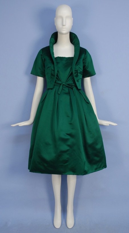CHRISTIAN DIOR SILK DRESS and JACKET SET, 1950's.: Sleeveless emerald green satin with square neckline, fitted bodice with self bow at waist, full skirt with large pleats over crinoline, matching short sleeve jacket with shawl collar. New York label. 