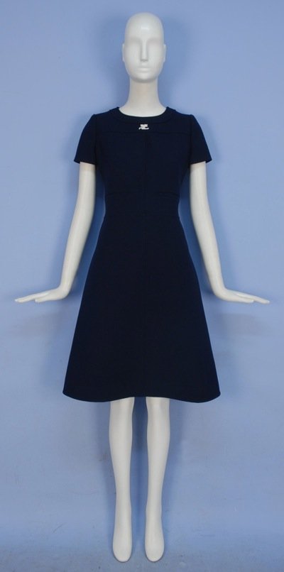 COURREGES PARIS WOOL DAY DRESS, 1960's.: Navy blue short sleeve with banded neck, front welt pockets and topstitch details, logo applique on yoke, back buttons, lot includes Courreges hanger. Labeled and stamped 95013. B-34, W-30, H-38, L-41