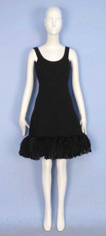 GEOFFREY BEENE FEATHER HEM COCKTAIL DRESS, 1960's.: Sleeveless black wool with scoop neck and squared armhole, empire waist and A-line skirt decorated with rooster feathers. Labeled. B-36, high W-32, L-38. Excellent.