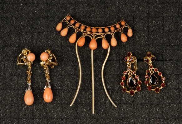 TWO PAIR 14K EARRINGS, 20th C.: One yellow gold pendant within loop design set with garnets. One yellow and white gold set with coral and tiny diamonds. 14.9 dwt total. Together with a coral mounted hair comb. Excellent.