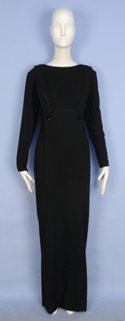GALANOS CREPE EVENING DRESS, 1970's.: Long sleeve black wool with suspender bib front crossing over back V-neck with button details, narrow silk binding, hidden pockets, zippered sleeve and deep back slit. B-34, W-26, L-60. Excellent.