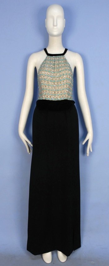 COURREGES COUTURE EVENING DRESS, 1970.: Cream silk halter bodice decorated with aqua and silver sequins in a striped pattern with crystal beads, velvet neck band, crossed back straps and waistband over black wool long skirt, lined in China 