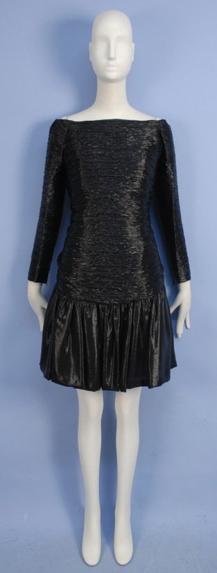 JEAN-LOUIS SCHERRER PARIS COCKTAIL DRESS, 1980s.: Ruched black and silver lurex with long off the shoulder sleeve, square neckline, dropped waist with back bow, self buttons and full short skirt. Boutique label stamped 562887, marked size 40. Excelle
