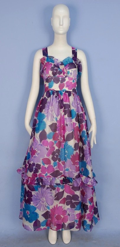 GIVENCHY PRINTED SILK SUMMER EVENING DRESS, c. 1980.: White silk gazar with stylized floral print, sleeveless with ruffled sweetheart bodice, wide crossed straps and wide high waistband, full skirt with below the knee ruffle, silk lining. Nouvelle Boutiq