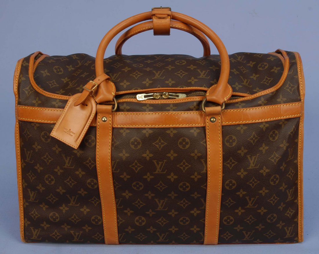 LOUIS VUITTON ZIP TOP WEEKENDER.: Twin handled duffle style bag in logo monogram vinyl with saddle tan leather trim, cotton lining having eight interior pockets with elastic top. Marked on trim "Louis Vuitton Paris Made in France" num